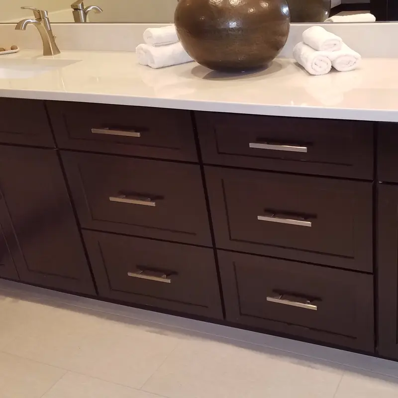 Double vanity with dark shaker cabinets and two faucets